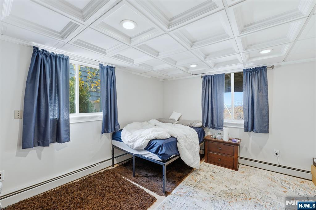 703 Stewart Street Ridgefield, NJ 07657 - Photo 27 of 38 a bedroom with furniture and a window