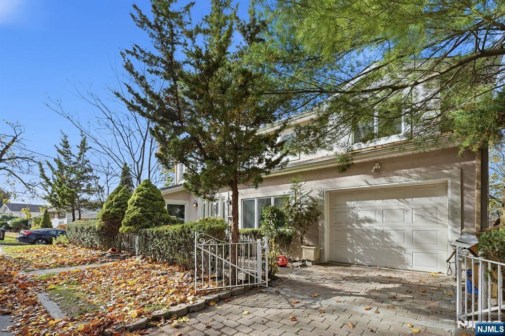 703 Stewart Street Ridgefield, NJ 07657 - Photo 3 of 38 a view of a house with a tree in front