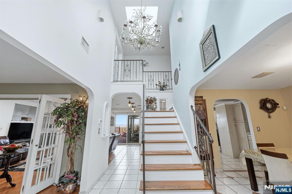 703 Stewart Street Ridgefield, NJ 07657 - Photo 5 of 38 a view of hall way with furniture and a flat screen tv