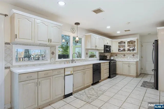 a kitchen with a sink window and cabinets