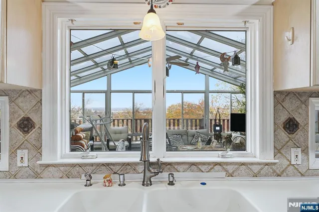 a view of a bathroom with a tub and a large window