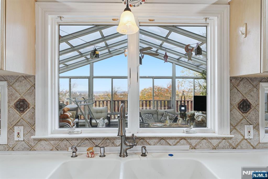 703 Stewart Street Ridgefield, NJ 07657 - Photo 8 of 38 a view of a bathroom with a tub and a large window