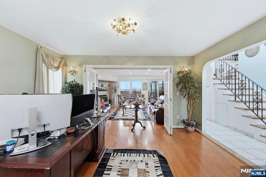 703 Stewart Street Ridgefield, NJ 07657 - Photo 10 of 38 a kitchen with furniture and a flat screen tv