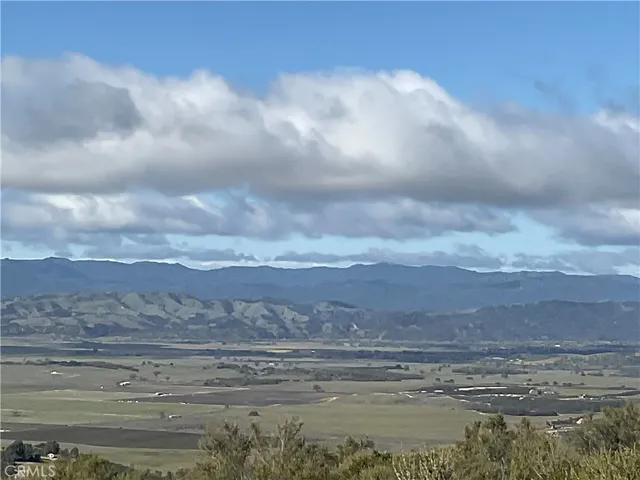 a view of a road with mountains in the background