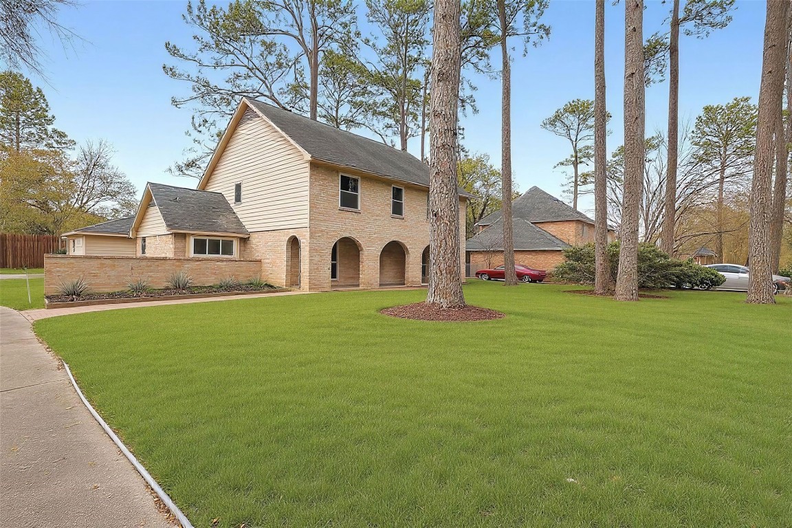 a view of a white house with a yard and sitting area