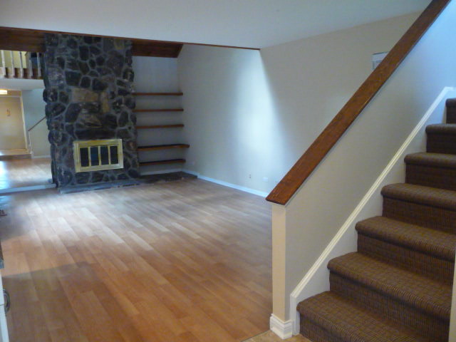694 Chandler Road Gurnee, IL 60031 - Photo 3 of 16 a view of entryway with wooden floor and stairs