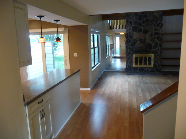 694 Chandler Road Gurnee, IL 60031 - Photo 4 of 16 a view of a hallway with wooden floor and a living room