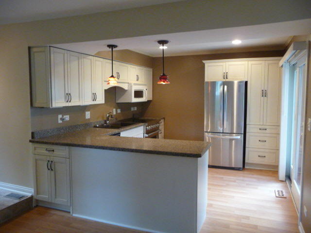 694 Chandler Road Gurnee, IL 60031 - Photo 6 of 16 a kitchen with stainless steel appliances granite countertop a sink and a refrigerator