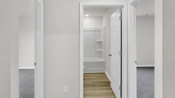 a view of a bathroom from a hallway