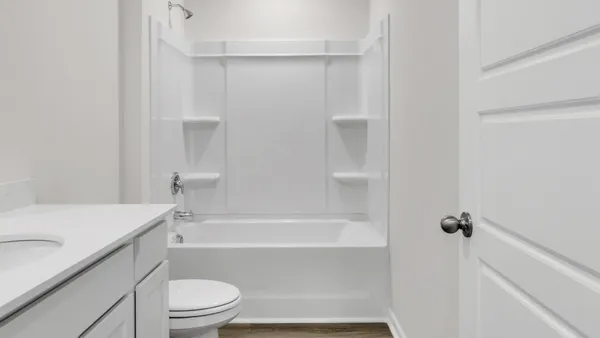 a bathroom with a bathtub a toilet and a sink