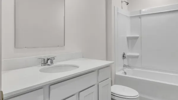 a bathroom with a sink toilet vanity and shower