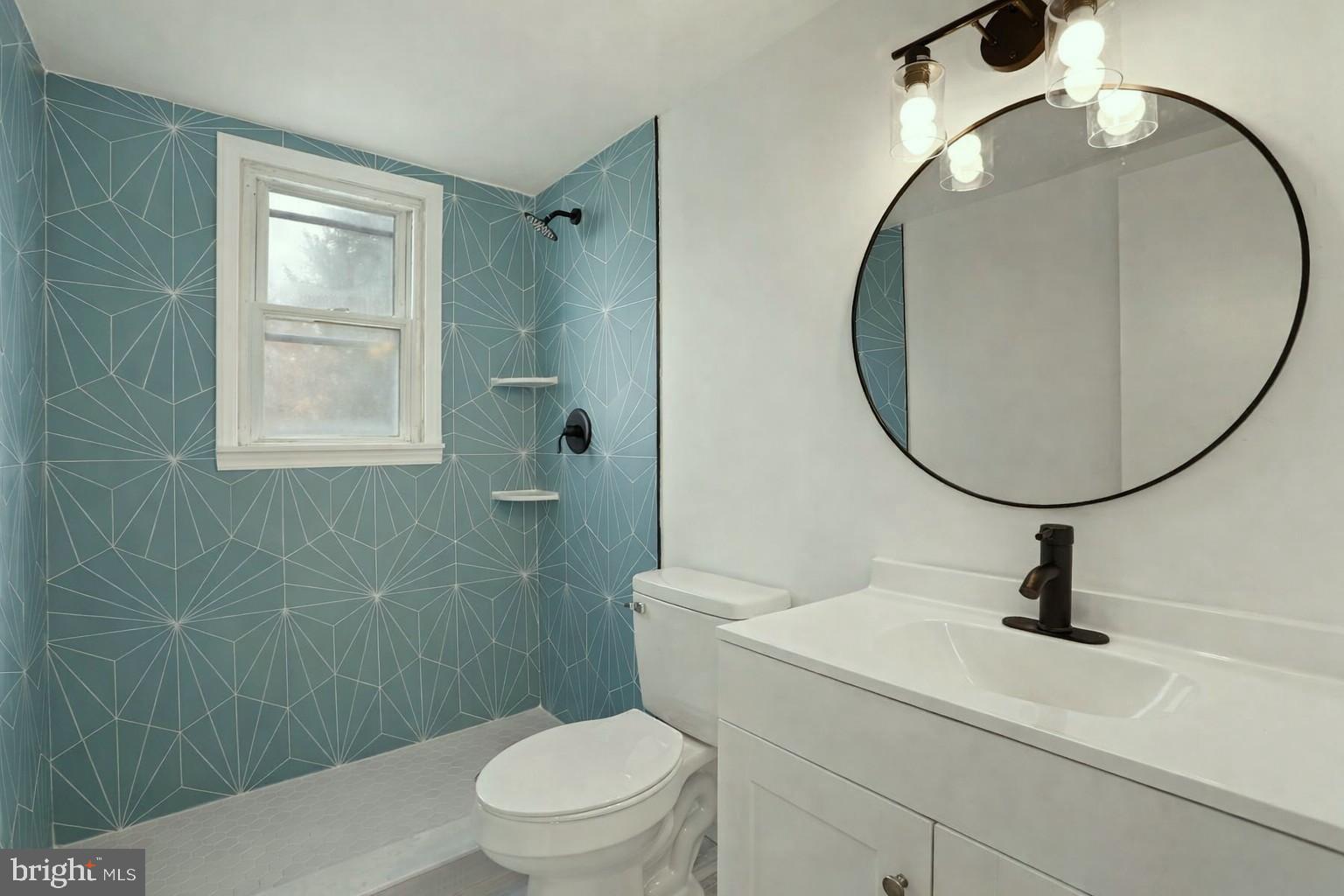 15205 Michigan Rd. Woodbridge, VA 22191 - Photo 20 of 20 a bathroom with a sink a toilet and a mirror