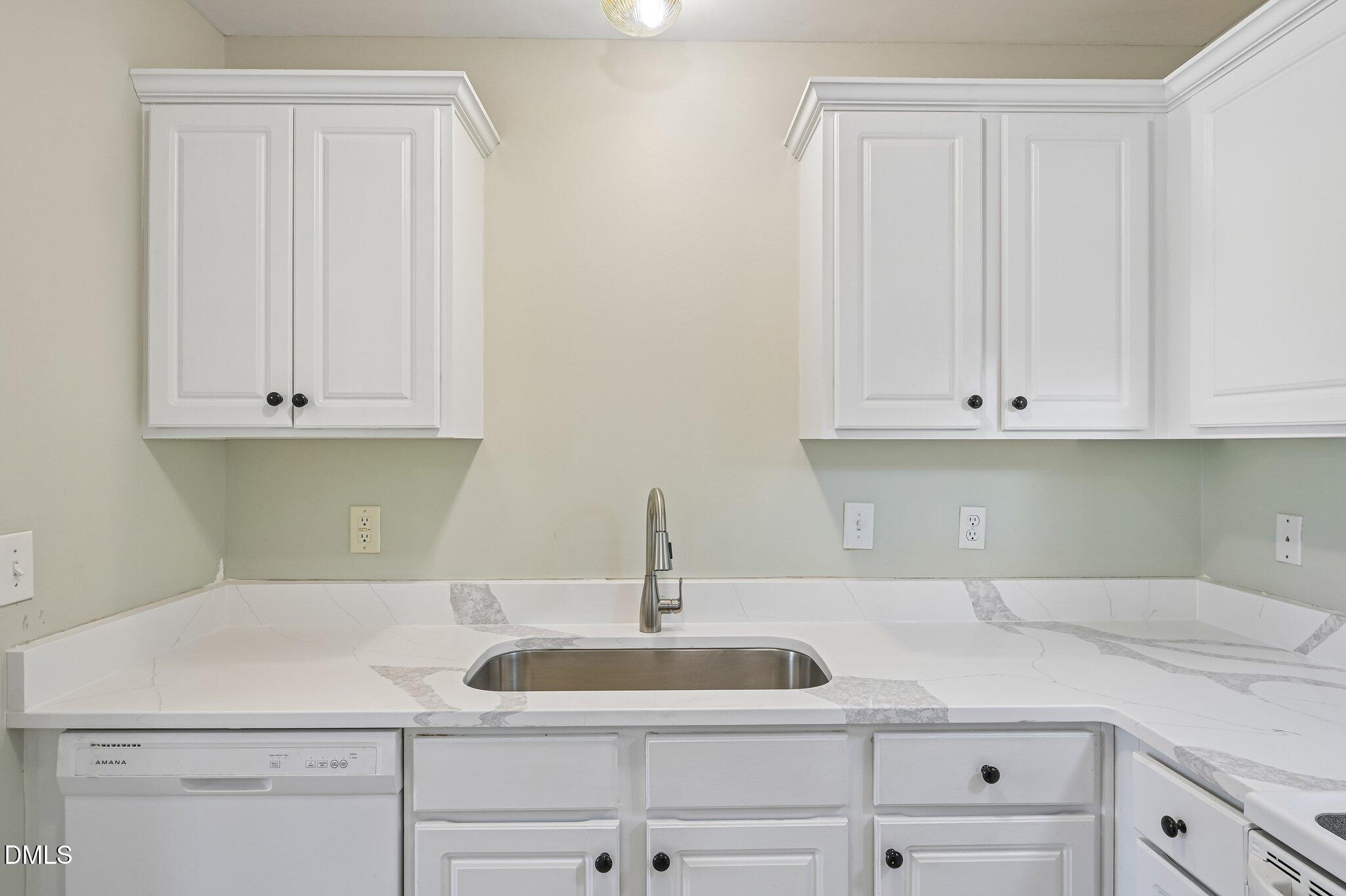 278 South Raleigh Street Angier, NC 27501 - Photo 11 of 35 a kitchen with white cabinets and a sink