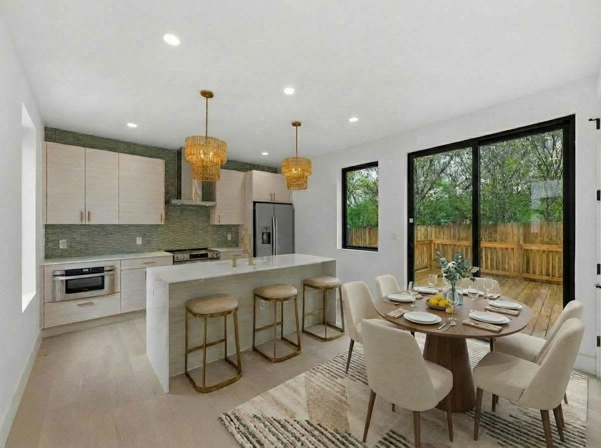 a kitchen with a dining table chairs stove and white cabinets