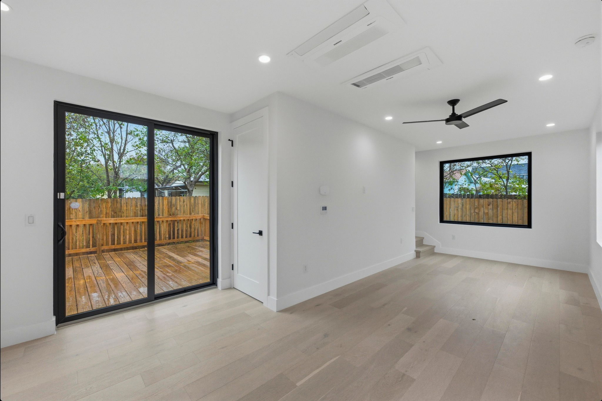 802 Philco Drive, Unit 2 Austin, TX 78745 - Photo 4 of 29 an empty room with windows and view of a hallway