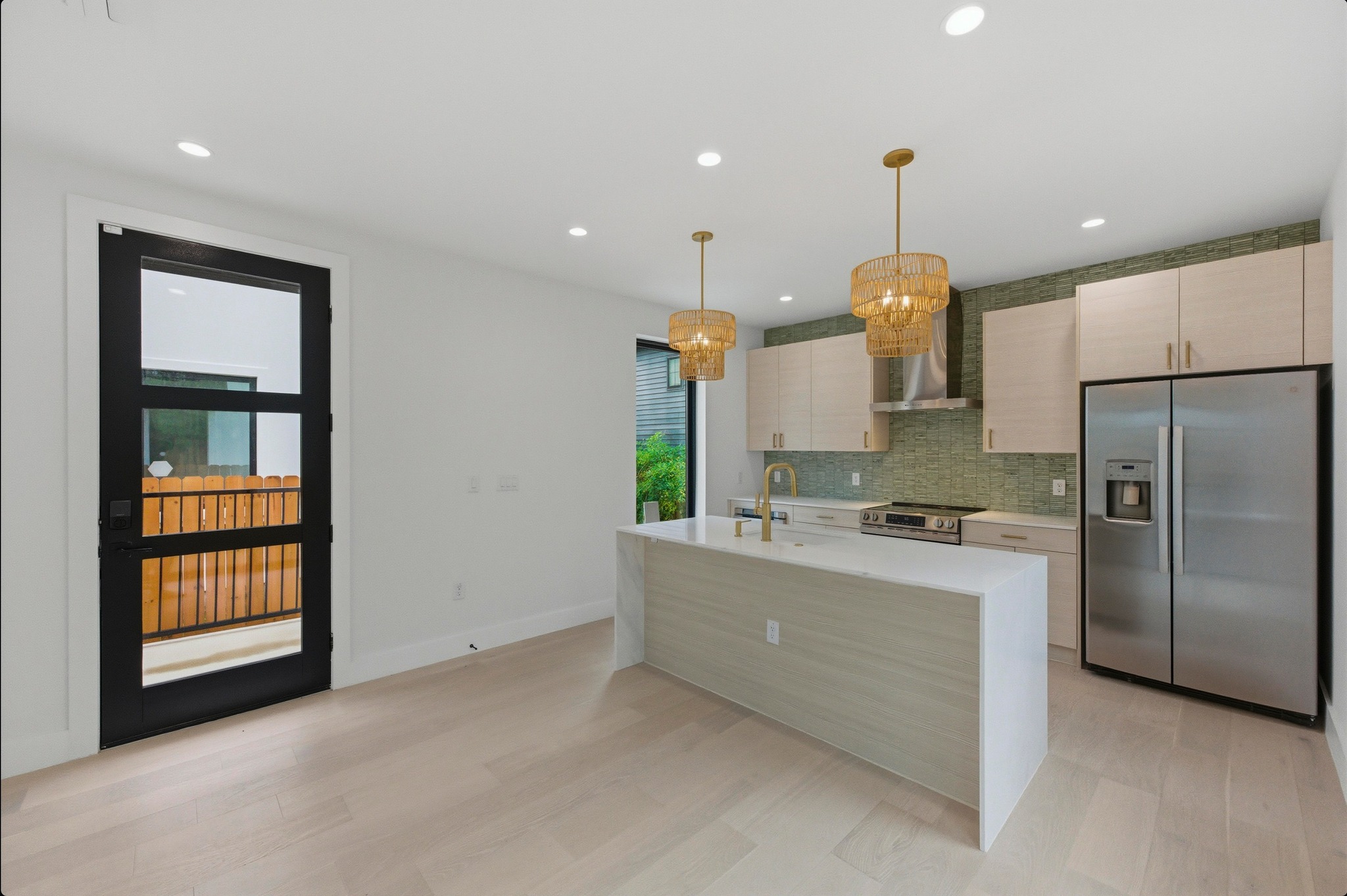 802 Philco Drive, Unit 2 Austin, TX 78745 - Photo 6 of 29 a kitchen with kitchen island a counter top space stainless steel appliances and a window