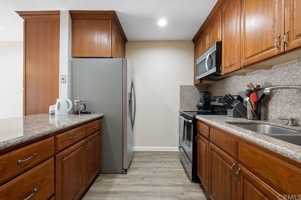 1085 Driftwood Circle Placentia, CA 92870 - Photo 5 of 18 a kitchen with granite countertop stainless steel appliances a sink and cabinets