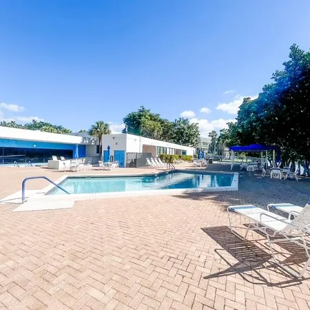 a view of swimming pool with outdoor seating and plants