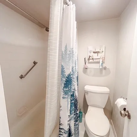 a white toilet sitting next to a bathroom sink