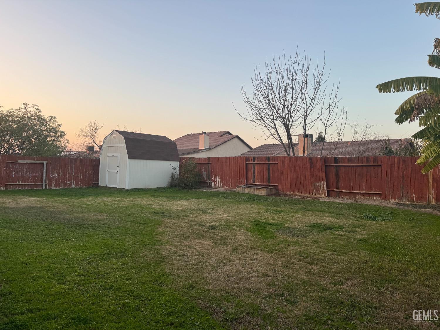 Undisclosed Address Bakersfield, CA 93307 - Photo 2 of 12 a backyard of a house with lots of green space