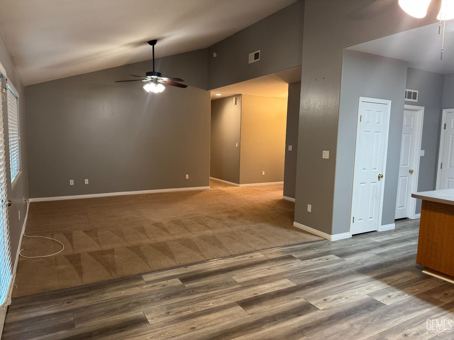 Undisclosed Address Bakersfield, CA 93307 - Photo 4 of 12 an empty room with wooden floor and windows