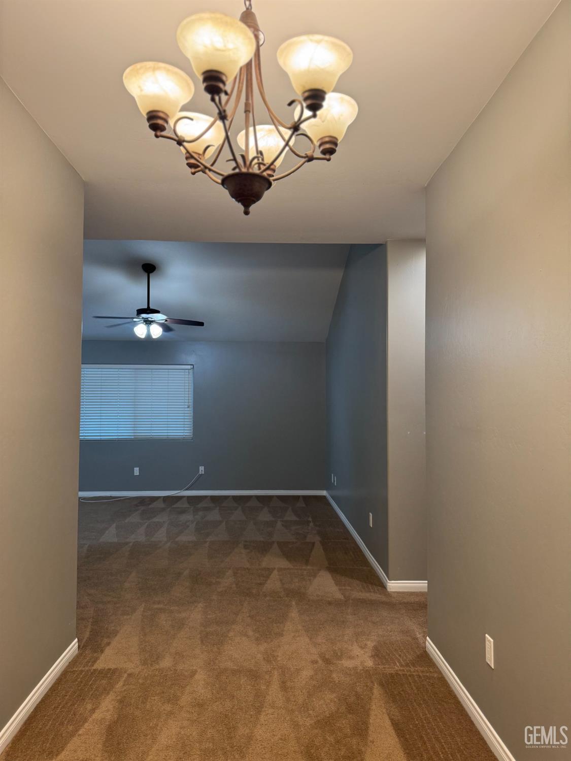 Undisclosed Address Bakersfield, CA 93307 - Photo 10 of 12 a view of a chandelier fan and wooden floor