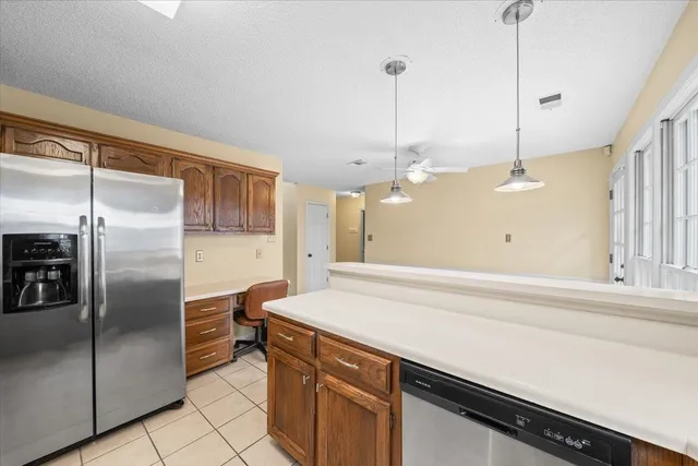 a kitchen with a refrigerator a sink and a stove top oven