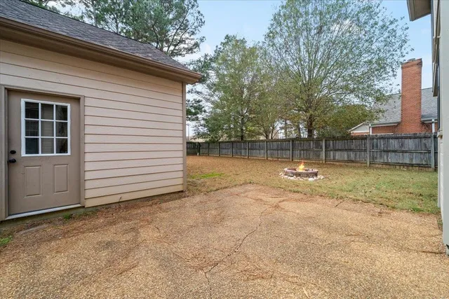 a view of a backyard with large trees