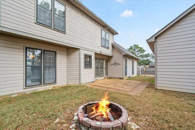 a view of a house with a backyard and porch