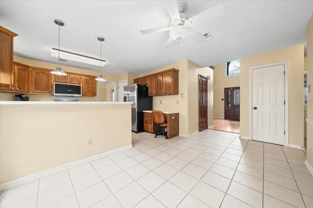 a view of a kitchen with furniture and a refrigerator
