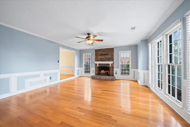 a view of empty room with fireplace and window