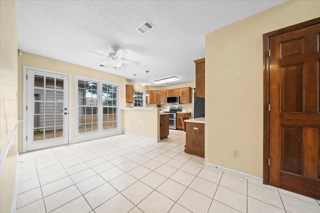 a view of a kitchen with furniture and a refrigerator
