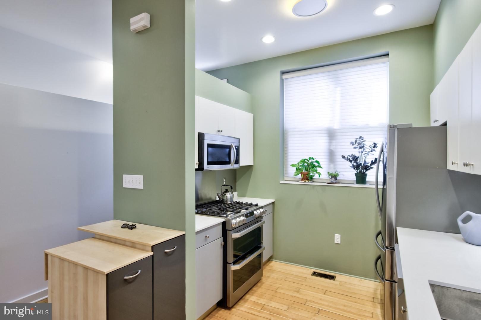 1325 Webster Street Philadelphia, PA 19147 - Photo 4 of 20 a kitchen with a sink cabinets and wooden floor