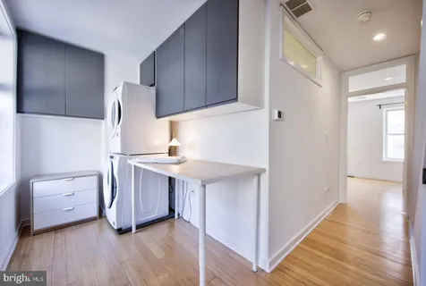 a kitchen with stainless steel appliances a refrigerator and a stove top oven