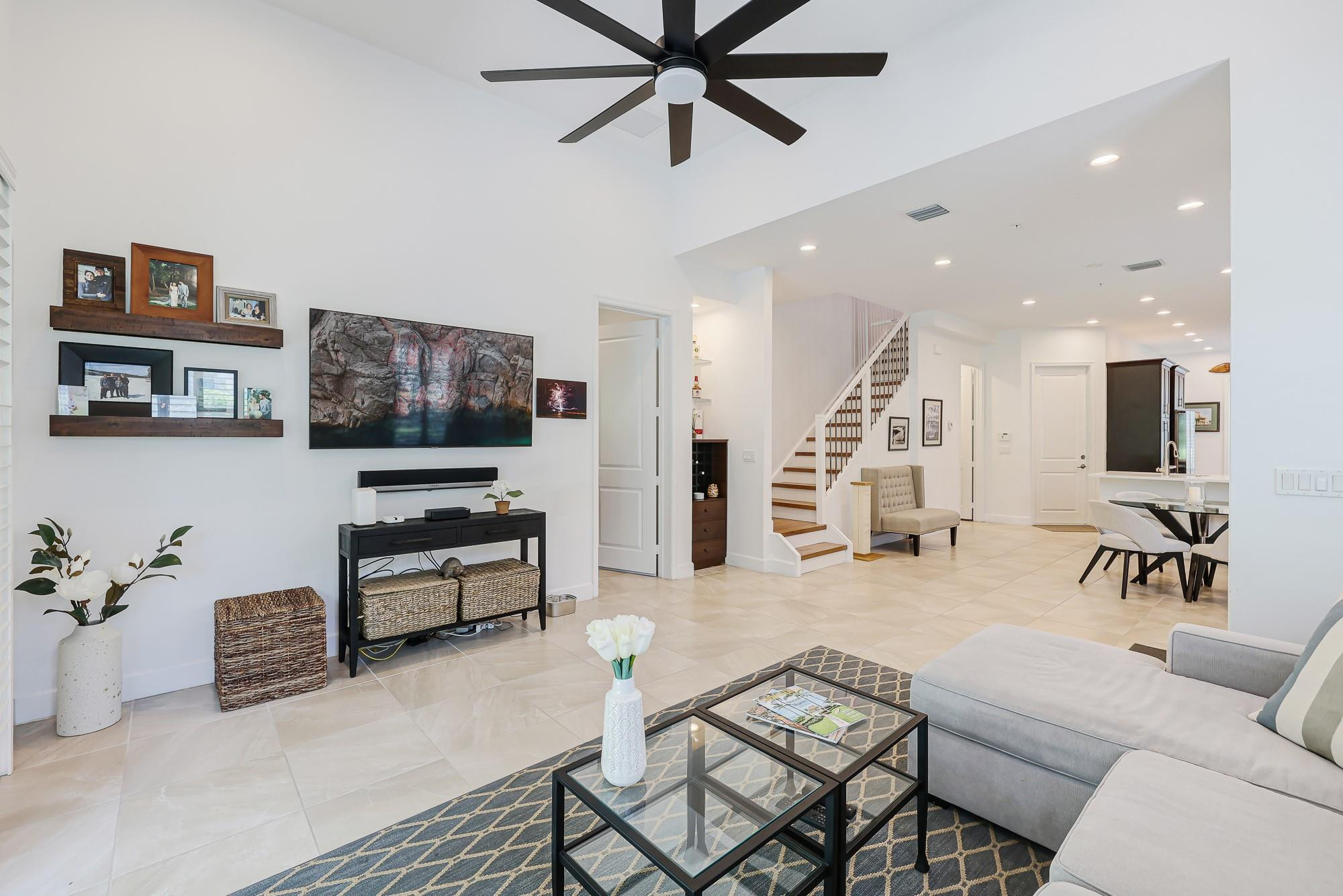 22954 Clear Echo Drive, Unit 31 Boca Raton, FL 33433 - Photo 14 of 38 a living room with furniture and a flat screen tv