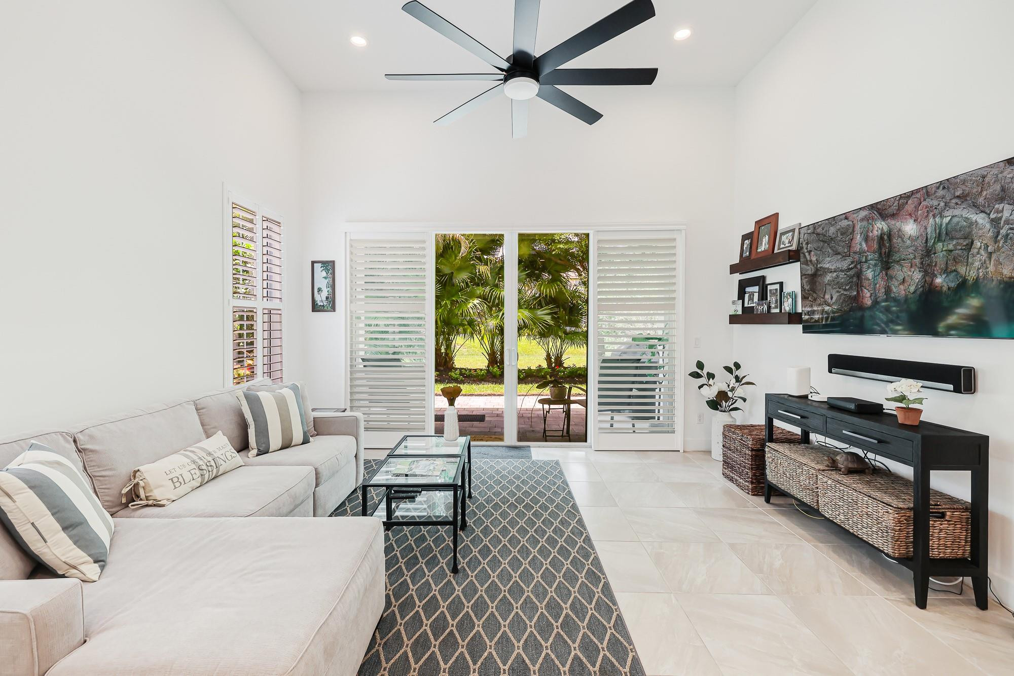 22954 Clear Echo Drive, Unit 31 Boca Raton, FL 33433 - Photo 15 of 38 a living room with furniture and a flat screen tv