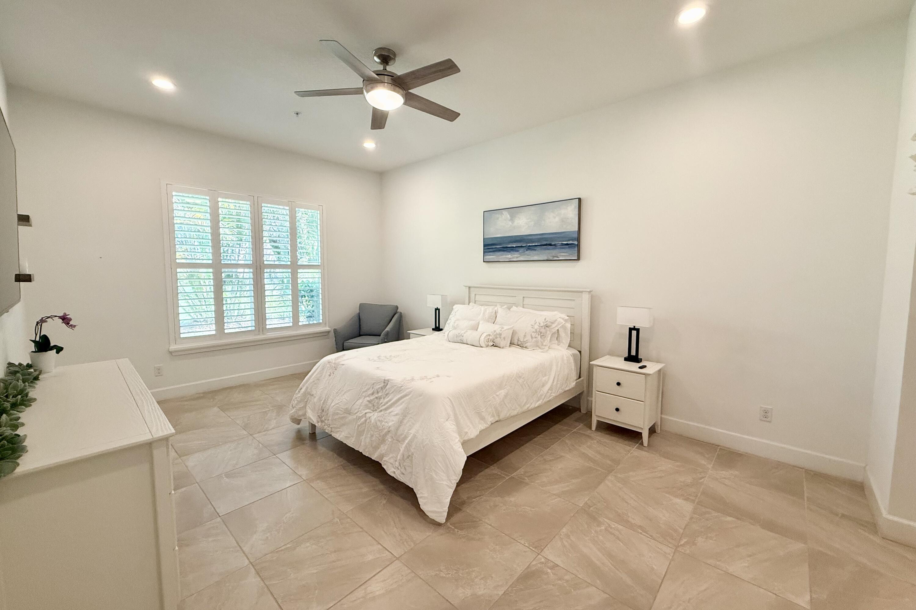 22954 Clear Echo Drive, Unit 31 Boca Raton, FL 33433 - Photo 16 of 38 a spacious bedroom with a bed and a window