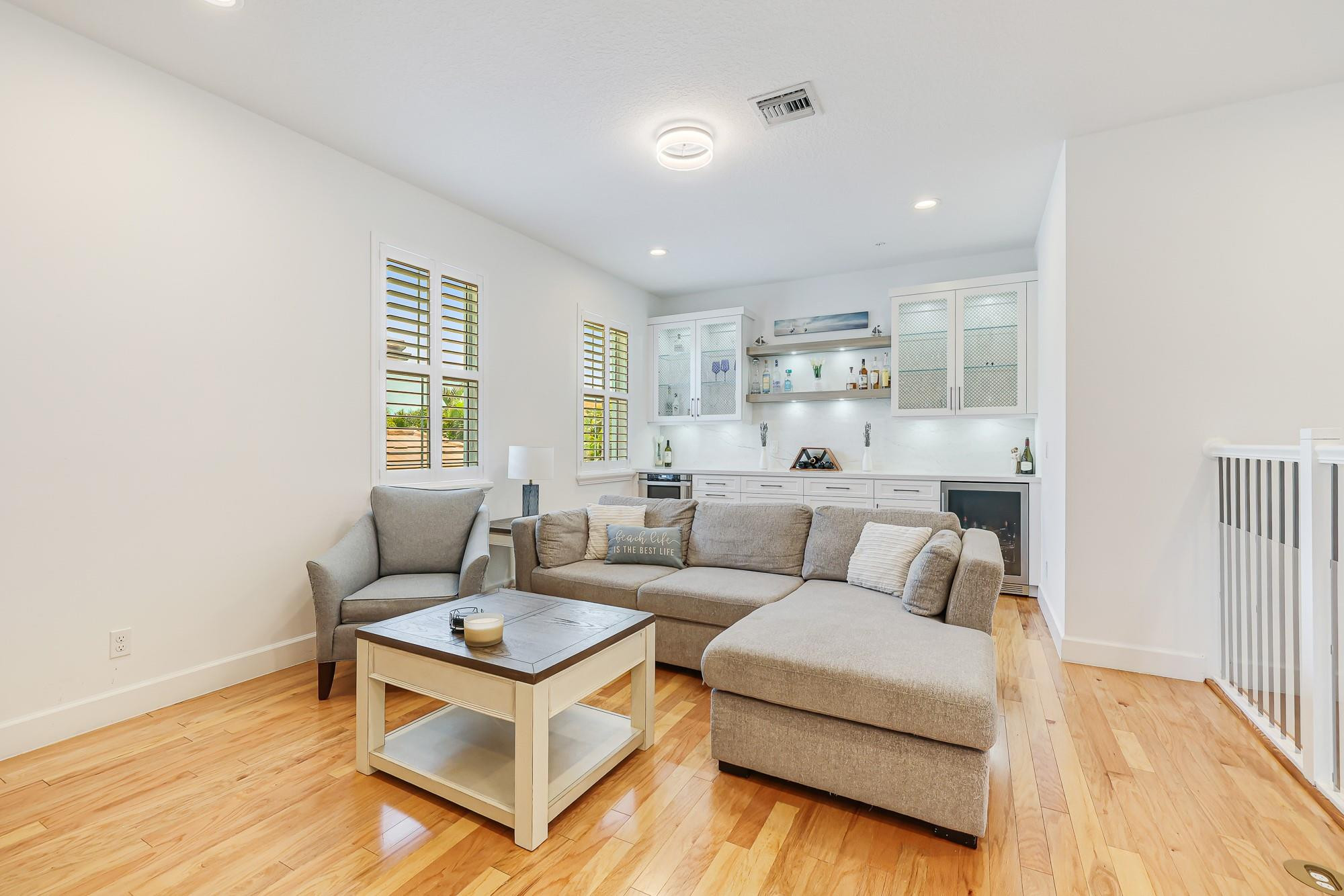 22954 Clear Echo Drive, Unit 31 Boca Raton, FL 33433 - Photo 22 of 38 a living room with furniture and a wooden floor