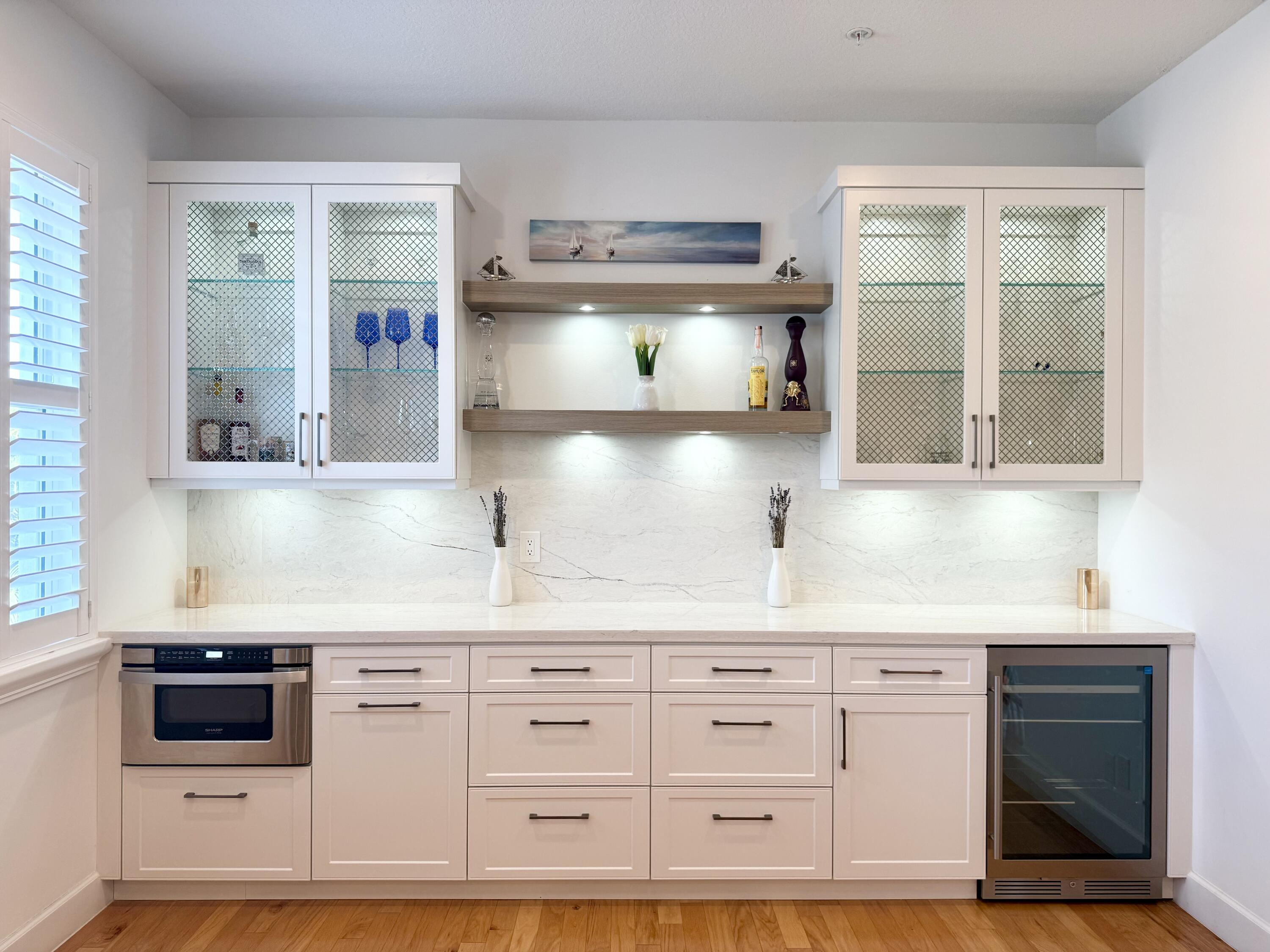 22954 Clear Echo Drive, Unit 31 Boca Raton, FL 33433 - Photo 23 of 38 a kitchen with white cabinets and window