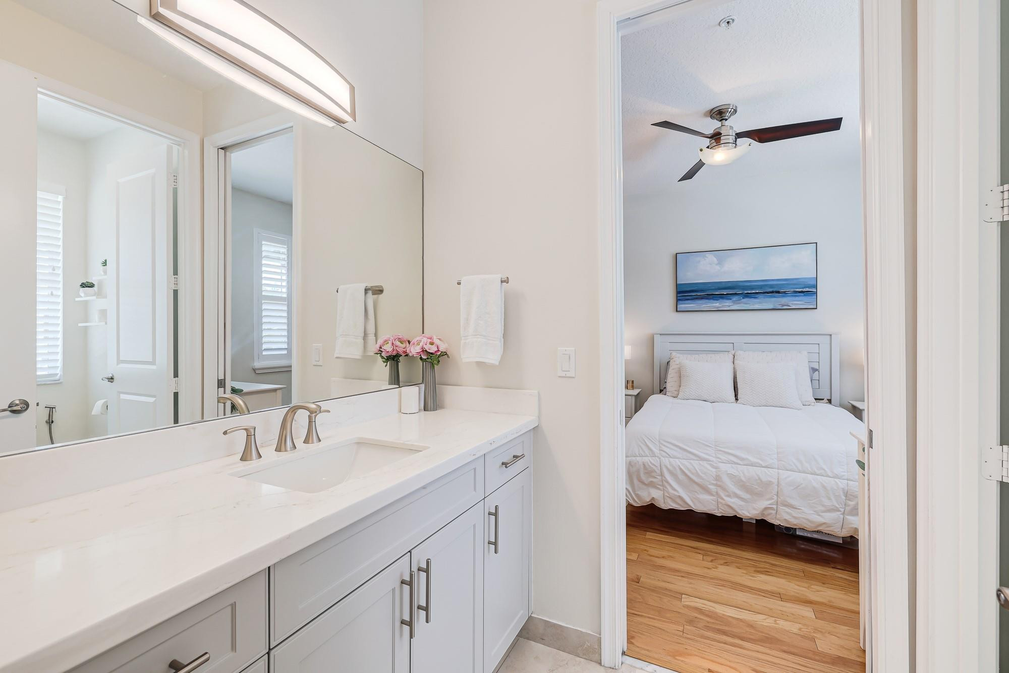 22954 Clear Echo Drive, Unit 31 Boca Raton, FL 33433 - Photo 27 of 38 a en suite bathroom with a double vanity sink and a mirror