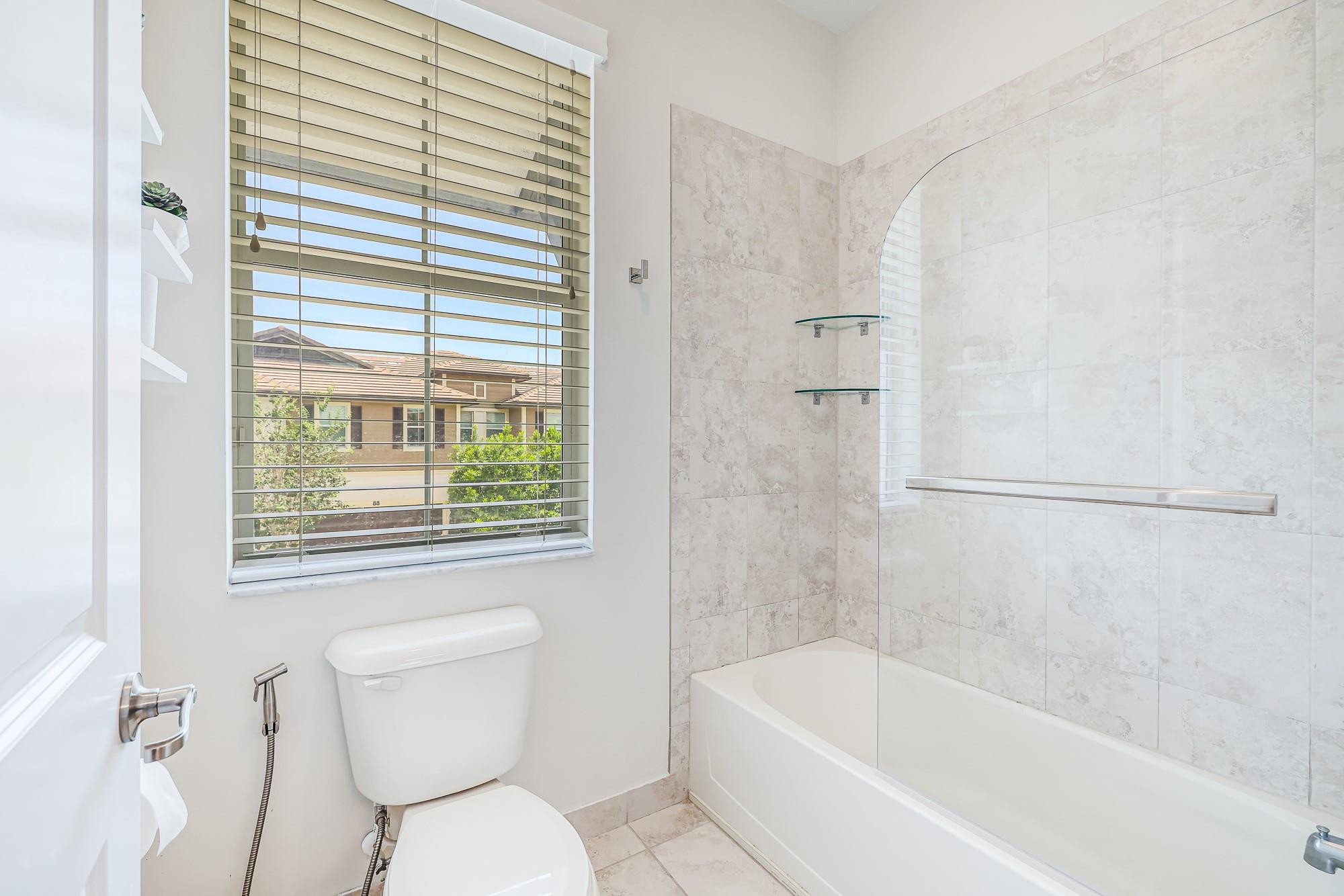 22954 Clear Echo Drive, Unit 31 Boca Raton, FL 33433 - Photo 28 of 38 a white toilet sitting next to a bath tub