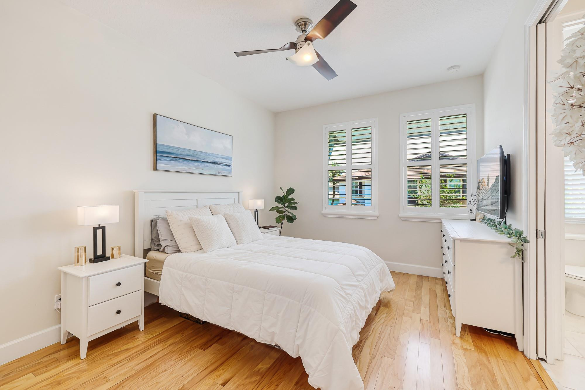 22954 Clear Echo Drive, Unit 31 Boca Raton, FL 33433 - Photo 29 of 38 a bedroom with a bed and a large window