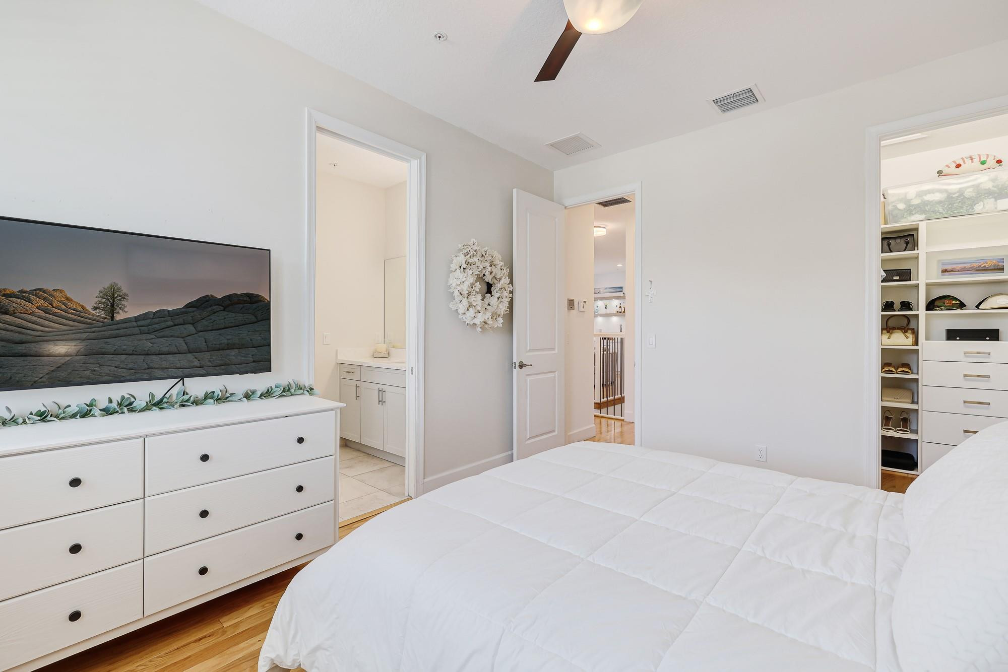 22954 Clear Echo Drive, Unit 31 Boca Raton, FL 33433 - Photo 30 of 38 a bedroom with a bed and a dresser in it