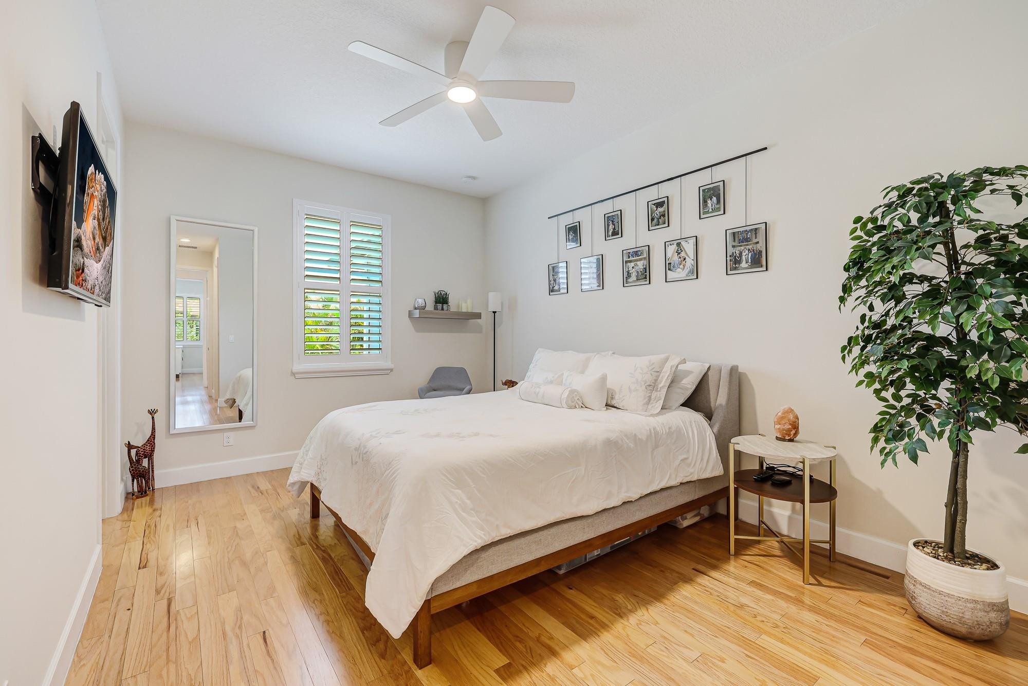 22954 Clear Echo Drive, Unit 31 Boca Raton, FL 33433 - Photo 31 of 38 a spacious bedroom with a bed and a potted plant