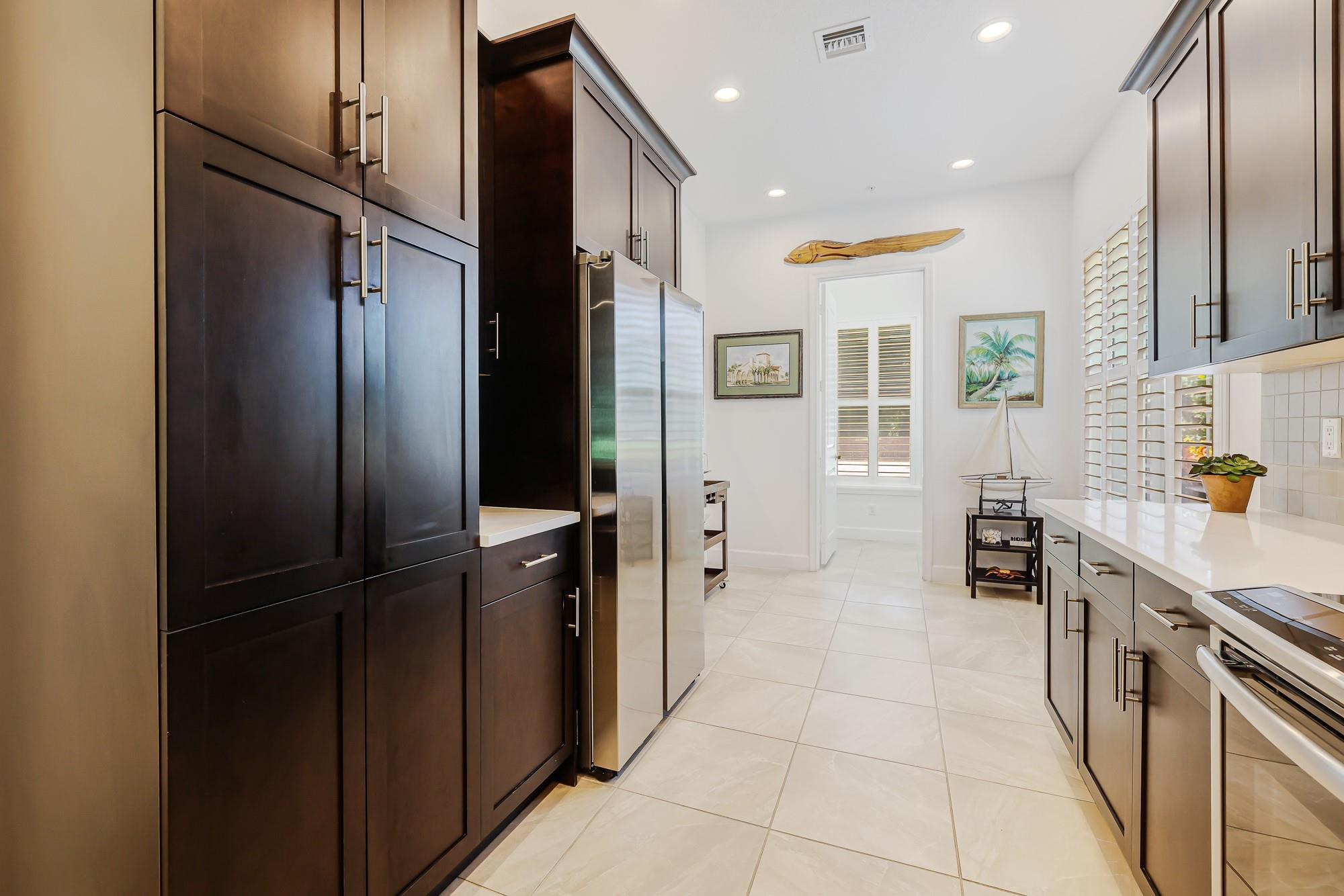 22954 Clear Echo Drive, Unit 31 Boca Raton, FL 33433 - Photo 8 of 38 a kitchen with stainless steel appliances granite countertop a refrigerator and a sink