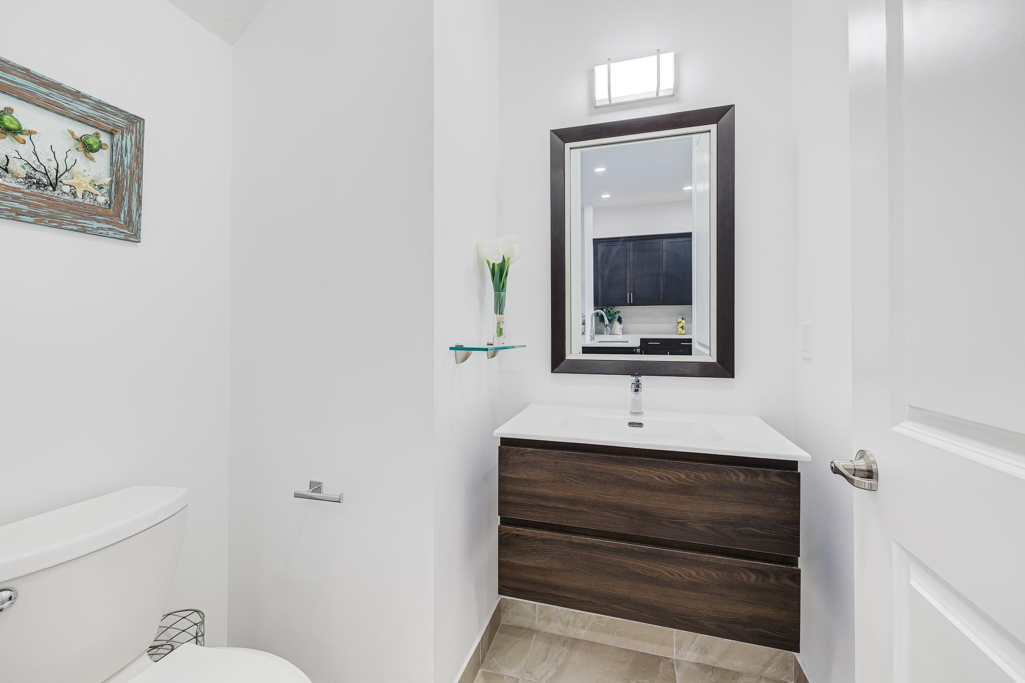 22954 Clear Echo Drive, Unit 31 Boca Raton, FL 33433 - Photo 10 of 38 a bathroom with a sink and a mirror