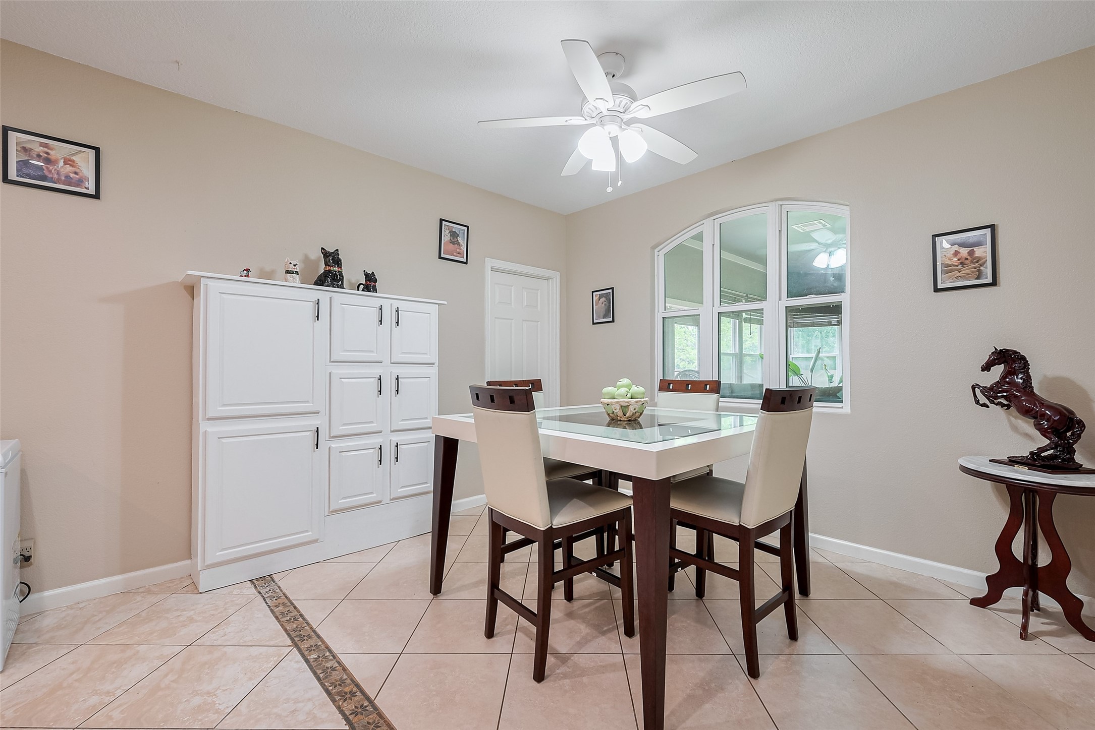 2499 Southline Road Conroe, TX 77384 - Photo 20 of 49 Cozy breakfast area with tile flooring and a large arched window bringing in natural light.