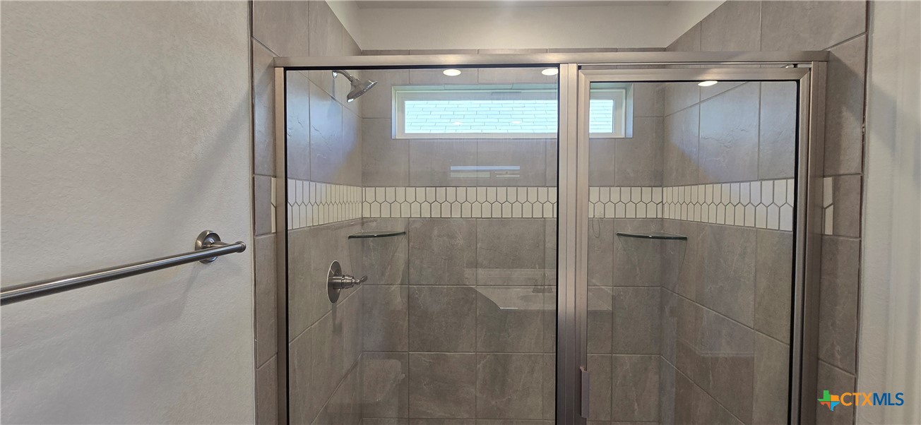 334 Monty Road Copperas Cove, TX 76522 - Photo 14 of 17 a bathroom with a glass shower door