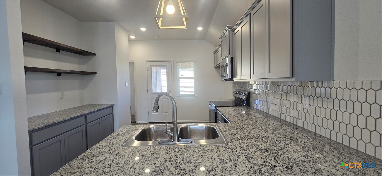 334 Monty Road Copperas Cove, TX 76522 - Photo 3 of 17 a kitchen with sink cabinets and window