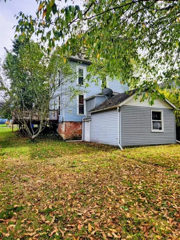 a backyard of a house with a large tree